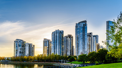 Sunset as the sun is setting behind modern Skyscapers lining the skyline of Yaletown along False Creek Inlet of Vancouver, British Columbia, Canada