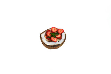 coconut cut with banana and strawberry slices with mint on white background