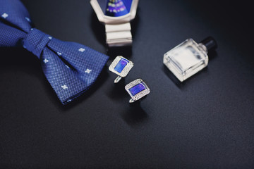 luxury men's cufflinks and watch close up.