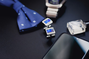 Luxury blue fashion men`s cufflinks. accessories for tuxedo, butterfly, tie and smartphone with screen