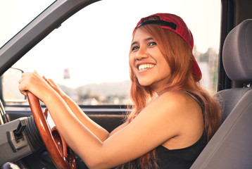 Asian trendy cool woman driving car with bright sun - Happy ethnic diverse Thai girl inside vehicle...