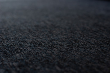 dark gray textile material perspective soft focus textured background surface