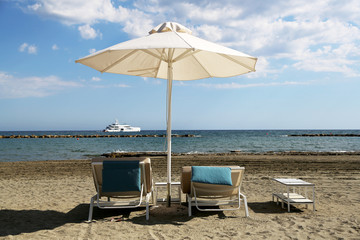 Stylish lounger in yellow sand to sun sunbed on beach