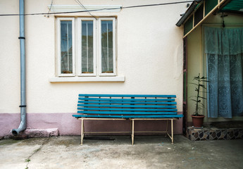 Plakat bench in front of old house