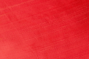 Close up of a woolen fabric of red scarlet color. Abstract canvas background, empty template.