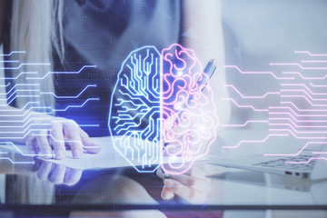 Multi exposure of woman's writing hand on background with brain hud. Concept of learning.