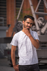 Male model posing in front of old industrial river