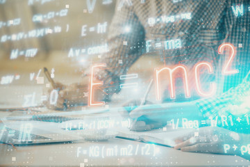 Science formula hologram with man working on computer on background. Education concept. Double...