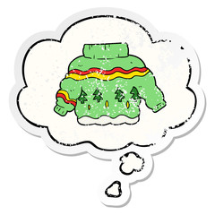 cartoon christmas jumper and thought bubble as a distressed worn sticker