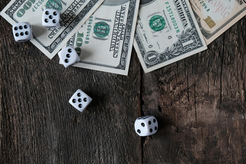 Gaming dice and US dollars, the concept of gambling addiction.