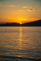 Paddle boarding during a sunset in the open ocean