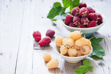 Fresh organic white gold and red raspberry in a bowl 