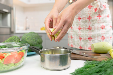 Woman preparing delicious and healthy food in the home kitchen. Healthy diet concept