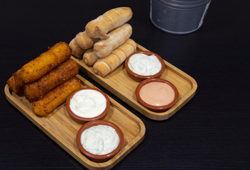 Wooden board with variety of tequeños typical of Venezuela