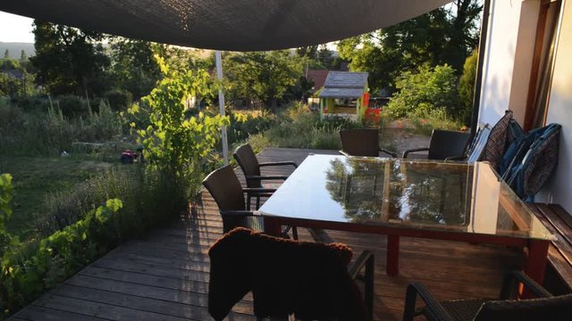 Garden terrace patio shade flowers table bbq summer evening sunset