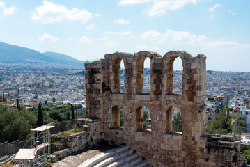 Fototapeta na wymiar Ancient stone theater with marble steps of Odeon of Herodes Atticus on the southern slope of the Acropolis. Athens, Greece. The Odeon is the main scene of the Athenian festival.