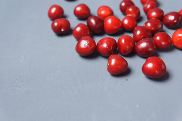 Red sweet cherry scattered on a gray background
