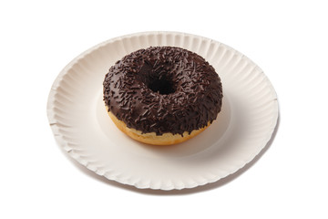 Sweet doghnut in chocolate glaze decorated with sprinkles on a paper plate isolated on a white background