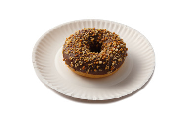 Sweet doghnut in chocolate glaze decorated with sprinkles on a paper plate isolated on a white background