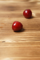 Red sweet cherry scattered on a wooden table
