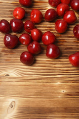 Red sweet cherry scattered on a wooden table