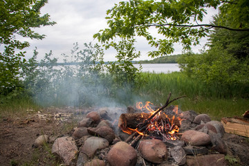 Camp Fire in Forest near Lake