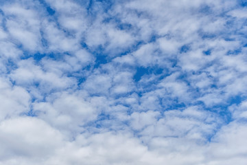 light fluffy clouds on a bright blue sky