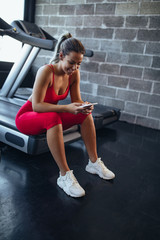 Fototapeta na wymiar Her fitness trainer comes in mobile form
