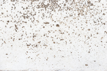Texture of peeling and cracking white paint on concrete wall