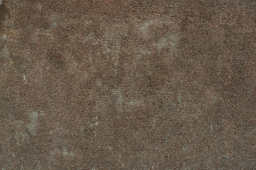 The texture of the concrete wall of very small stones and a lot of irregularities