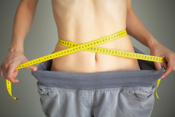 Diet. Woman in Sportswear Measuring Her Waist. Dieting concept