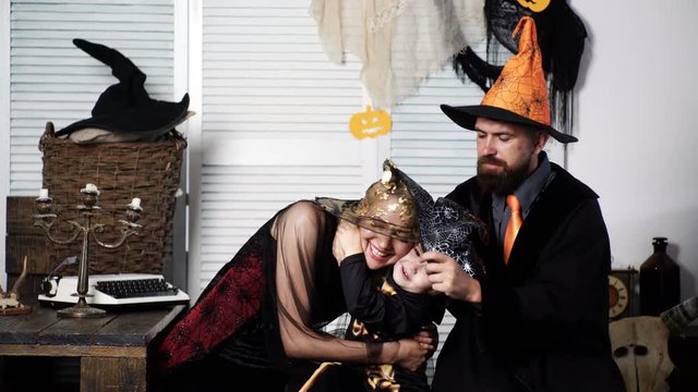 Family in costumes. Happy family on halloween. Happy family. Preparing for Halloween. Happy mother, father and child boy in costumes on celebration of Halloween. Trick or treat. Halloween concept.