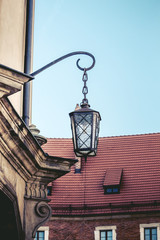 Fototapeta na wymiar Old lantern, medieval street light in the street on the light background in Krakow. Poland
