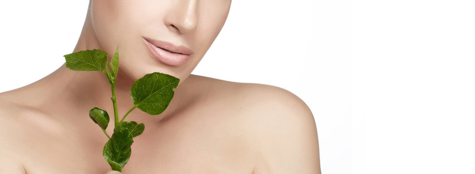Natural beauty healthy skin woman face with fresh green leaves. Closeup macro skin care concept