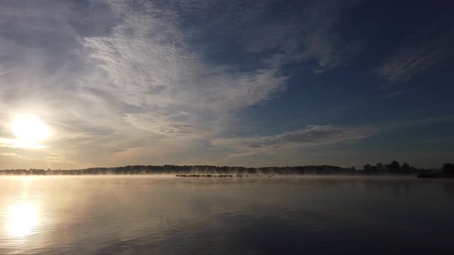 Panoramic view of a lake with sunrise during a boat ride