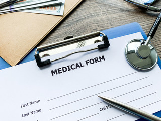 Medical form with patient data on doctor's desk