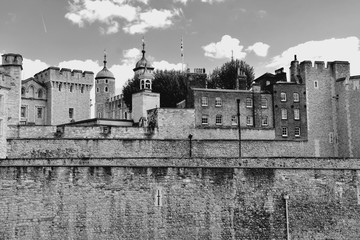 The famous White Tower and the Tower of London from South Bank across the River Thames. Popular historical tourist attraction on a summer day.
