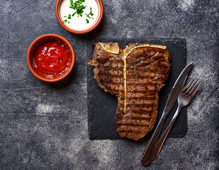 Grilled T-bone steak on dark background