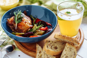 Grill Vegetables Chicken Bread and Mustard Broth. Tasty Dish Cooked Fried Barbeque Bird Hind Quarter, Carrot, Zucchini and Paprika Decorated Rosemary in Bowl on Wooden Board, Spoon and Fork Closeup