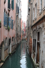 Fototapeta na wymiar Empty narrow canal in Venice