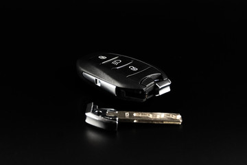 Modern car keys isolated on a black background with copy space for text or design elements. Car key...