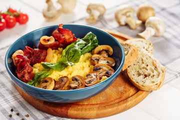 Polenta Italian Corn Porridge Pork Bacon Dish. Traditional Healthy Breakfast with Mushroom in Bowl...