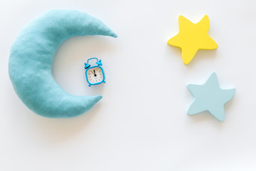 Sleep time concept with moon, stars, alarm clock on white background top view