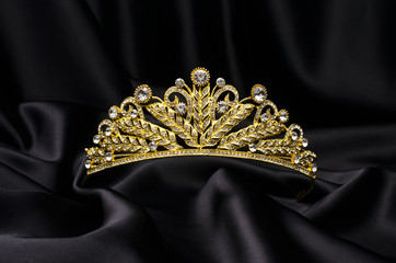 golden crown on a black silk - 276795664