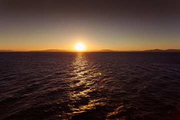 Awesome sunset over the sea with islands of Saronic Gulf background