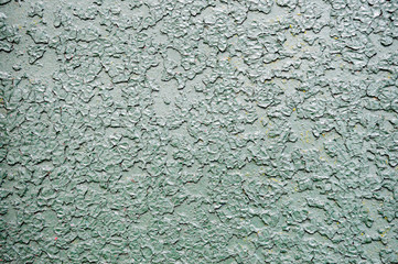 Texture of iron metal painted bright green peeling paint of old battered scratched cracked ancient rusty metal sheet wall with corrosion. The background