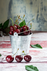 cherry in bucket on textured background