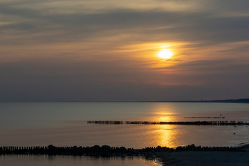 Beautiful fiery sunset sky on the beach. Sunrise over the sea and beautiful cloudscape.