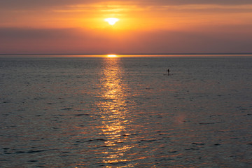 Beautiful fiery sunset sky on the beach. Sunrise over the sea and beautiful cloudscape.