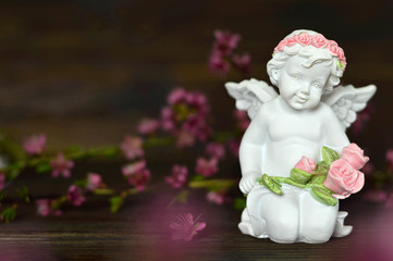 Condolence card. Angel holding bunch of roses